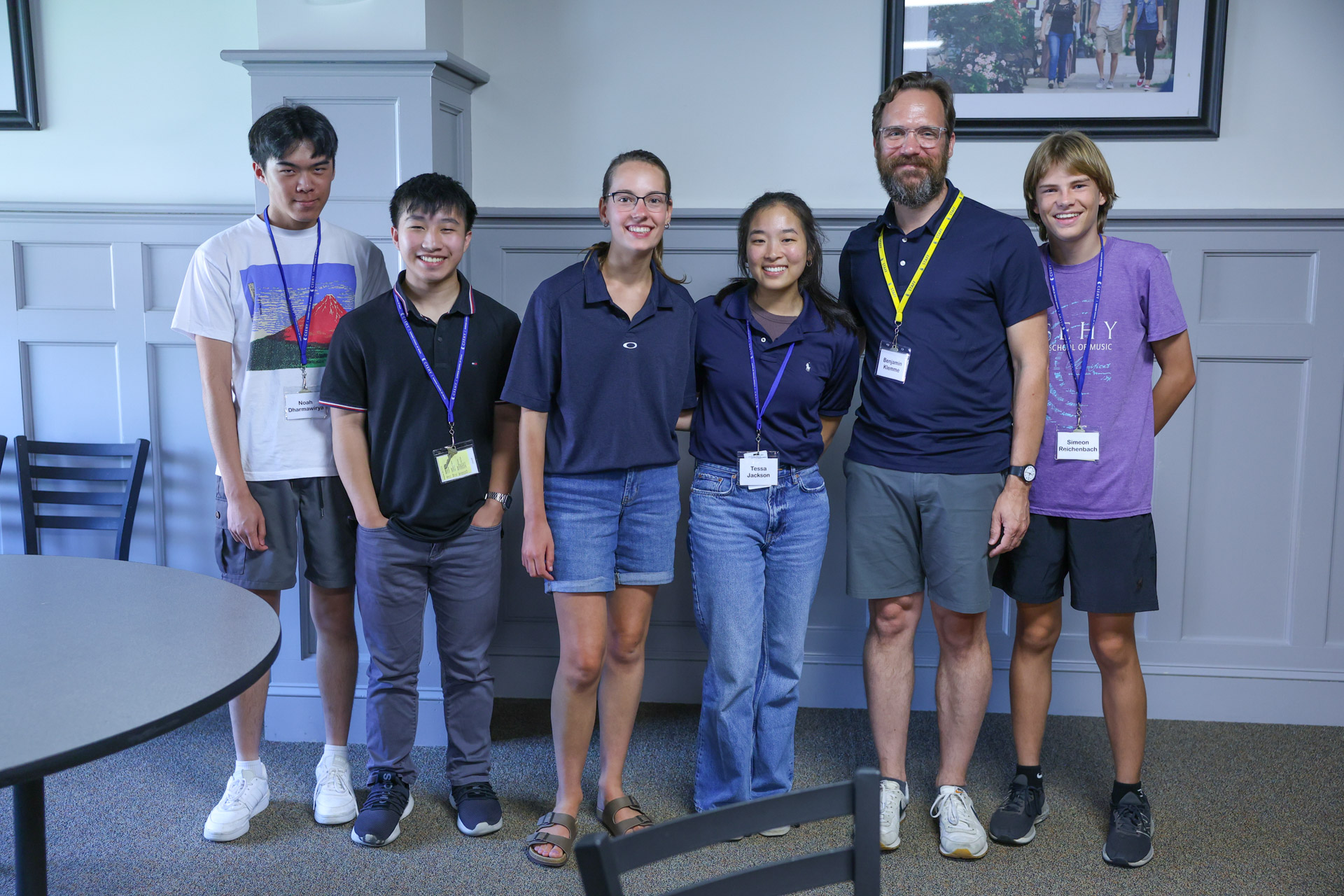professor stands with students